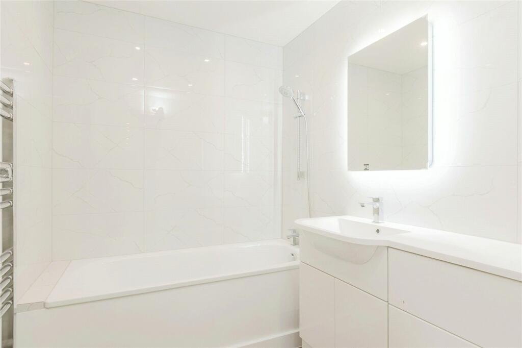 Finished bathroom with marble-effect tiling